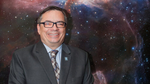 Xavier Barcons, ESO's Director General, stands in front of the Flame Nebula panel at ESO's Headquarters in Garching, Germany.